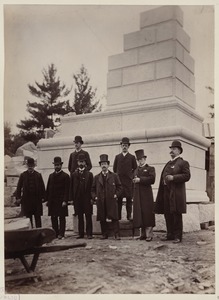 Dignitaries pose in front of mock-up of cornerstone for the McKim Building, assembled at the Milford Quarry