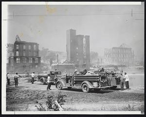 Fire and Water struck simultaneously in Mechanicsville, Conn., destroying textile mill and bleaching plant. Smoke still rises from shattered buildings where raging Quinebaug River went through. Fire apparatus was helpless before oil-fed flames.