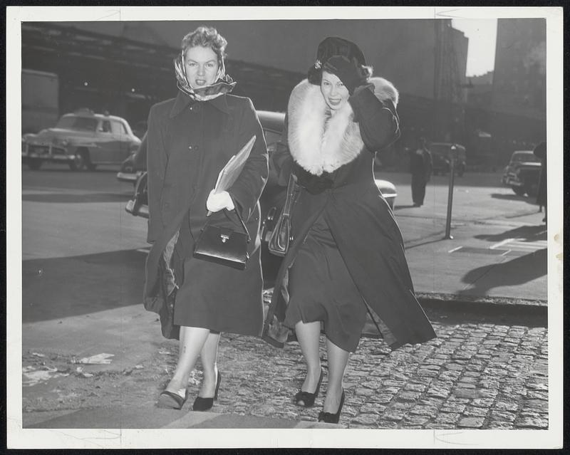 Br-r-r-risk Isn’t It, say these two young ladies as they brave the winter winds to return home from work yesterday afternoon.