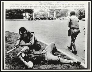 A Berkeley policeman gives first aid to a fallen comrade during anti war melee between radicals and police on University of California campus 4/15. The policeman was struck by a thrown object.