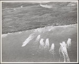 Air photo of 1st wave hitting beach - Tinian