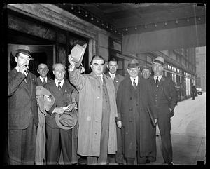 John Llewellyn Lewis, hat in hand, with a group of men in front of Hotel Statler, Boston