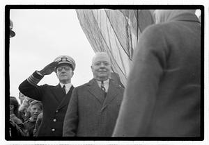 Boston Park Department Commissioner William Long in front of a officer saluting