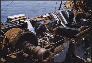 Reeling in catch on fishing boat