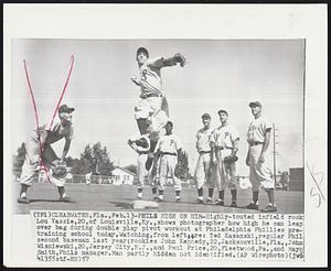 Phils High on Him -- Highly-touted infield rook Lou Vassie, 20, of Louisville, Ky., shows photographer how high he can leap over bag during double play pivot workout at Philadelphia Phillies pretraining school today. Watching, from left are: Ted Kazanski, regular Phil second baseman last year; rookies John Kennedy, 22, Jacksonville, Fla., John Wisniewski,20, Jersey City, N.J., and Paul Price, 20, Fleetwood, Pa., and Mayo Smith, Phils manager. Man partly hidden not identified.