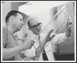 Unique silicone rubber membranes are the life-sustaining elements of a device that will perform the blood-oxygenating function of the human lungs during open - heart surgery or the treatment of some cardiac and pulmonary diseases. Dr. E. Converse Peirce (left) of Emory University, and Angelo Dounoucos of General Electric, inspect the fine structure of membrane "envelope."