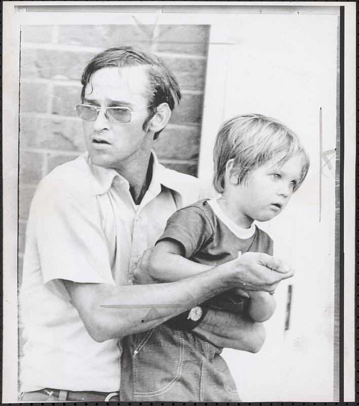 Holds knife on son