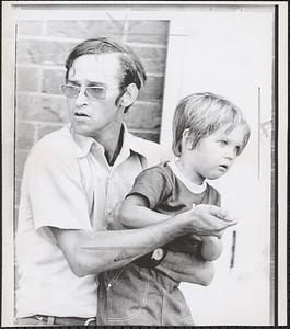 Holds knife on son