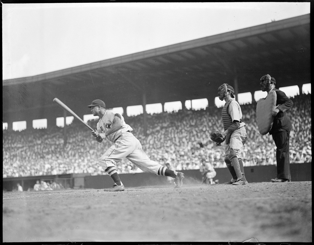 Catcher Jimmy Foxx of the Red Sox points to the outfield a…