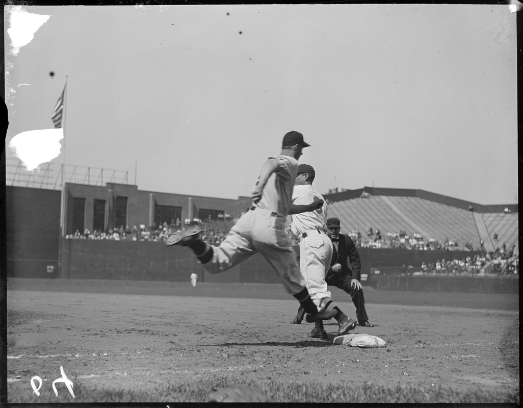 Joe Kuhel of the Senators out at first as the Sox' Eddie Morgan takes throw