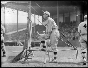 Baseball player Dizzy Dean, Boston, leaning on bats.