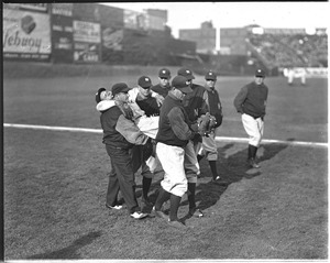 An injured Babe Ruth helped off Fenway Field by Yankee Teammates.