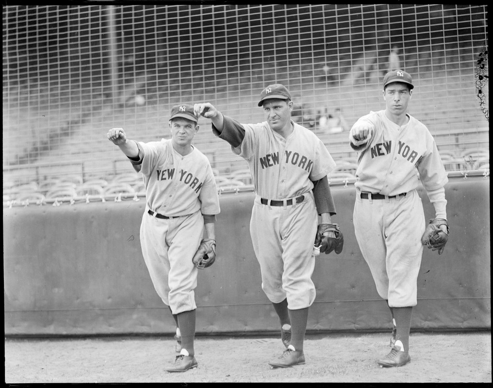 Joe DiMaggio and Yankee teammates in throwing pose.