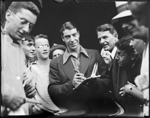 Joe DiMaggio signing autographs