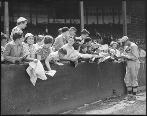 Dizzy Dean of the Cardinals sign autographs for young fans.