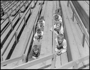 Kids stealing their seats in bleachers at Soldiers Field, Cambridge
