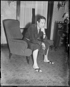 Max Baer looks thoughtful in his room at the Hotel Touraine