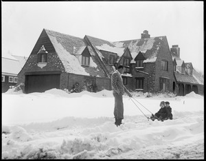 Jack Sharkey pulls his daughters Marilyn and Dorothy on sled in front of new $100,000 home in Chestnut Hill