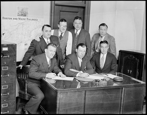 Fighters Ernie Schaaf, Jack Sharkey and Jim Maloney sign on the dotted line for fights at Boston Garden