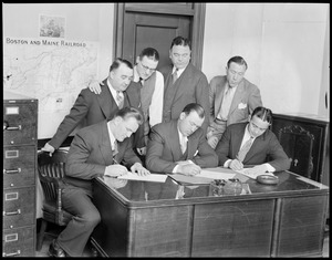 Fighters sign at Boston Garden seated L-R: Ernie Schaaf, Jack Sharkey, and Jim Maloney