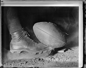 Stop action close-up of Wes Fesler of Harvard kicking ball