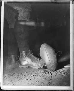 Stop action close-up of Wes Fesler of Harvard kicking ball
