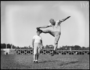 Boston University coach Al Masters watching Whitey Clem kick