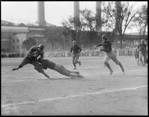 Marr of Pere Marquette tackled by Corcoran of the Quincy Trojans, Christopher Lee playground, South Boston. Pere Marquette won 12-0