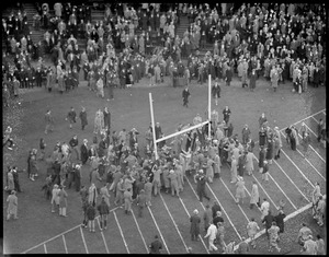 Crowd gathers, around goalposts after Harvard - Holy Cross game