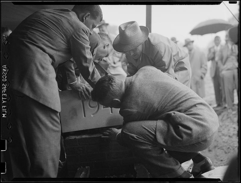 Four men placing cornerstone