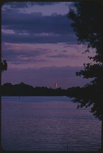 Sunset view across water with Prudential Tower in distance, Cambridge, Massachusetts