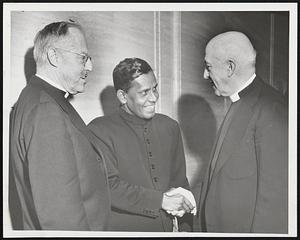 Churchman From India--The Rev. John P. Aaron, representing the United Church of South India, is greeted by two bishops at meeting of Massachusetts Church Service League in New England Mutual Hall yesterday. Left to right: Bishop Norman B. Nash of the Episcopal, diocese of Massachusetts; the Rev. Mr. Aaron; and Bishop A. Heron.