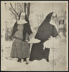Snowbound - Sister Mary Margaret (left) and Sister Mary Patrice of the Sisters of Divine Province, shovel their way to the main road from the Sacred Heart School in Plymouth. The snowstorm was the worst in 50 years for the Cape Cod area.