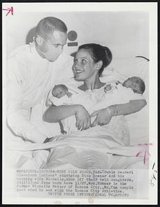 Double header! Cleveland Indians' shortstop Dick Howser and his beaming wife Michelle, show off their twin daughters, Jill (1) and Jana born here 1 1/27. Mrs. Howser is the former Michelle Metzer of Kansas City., Mo. The couple meet when he was with the Kansas City Athletics.