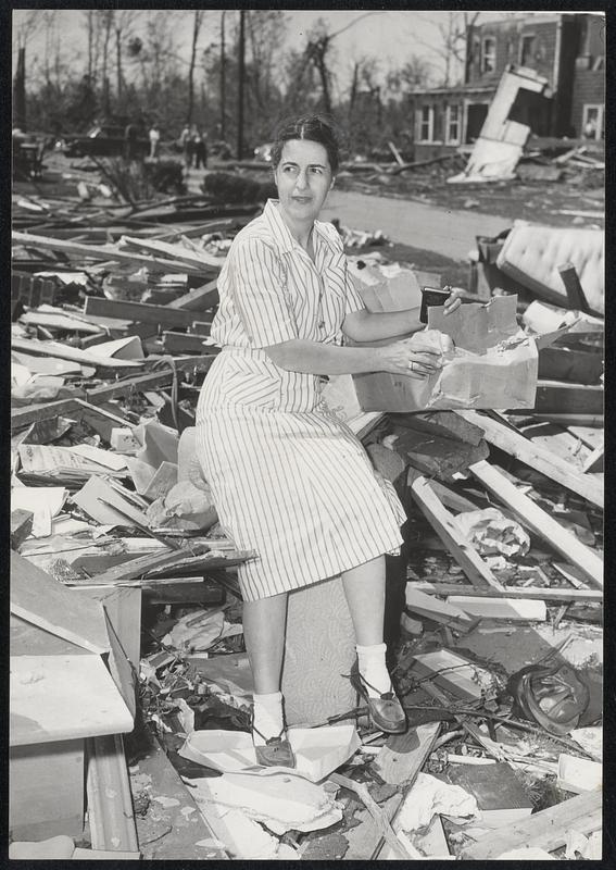 Searching for Precious Belongings among the ruins left by Tuesday night's hurricane are Mrs. Frances Donahue, who formerly called 8 Hapgood way, Shrewsbury, home; and Goodwin Graham, 28, formerly of 36 Somerset lane, Holden. Mrs. Donahue and her family were not at home when disaster struck. Graham suffered head and leg wounds, and his wife was hospitalized and his 18-months-old daughter escaped unharmed.