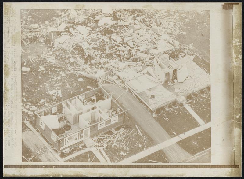 Belvidere, Ill. – Playthings Of The Storm – One of the many homes hit by the tornada here had its roof cleanly removed to afford a view of interior like a doll’s house. Home next door has only the floor and center center utility module remaining in place. Pieces