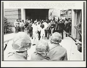 Columbus, Ohio: A small contingent of Ohio National Guard troops moves a group of student protesters from blocking 17th Avenue on the Ohio State University campus 5/5. Guardsmen did not have to use tear gas. Bricks were hurled at guardsmen and two were treated at a nearby hospital for a broken arm and a fractured jaw.