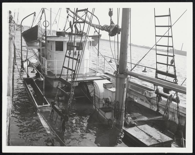 Fairhaven Wreck-Battered and filled with sea water, the Aloha, home port New Bedford, wallows beside Kelly's marine dock at Fairhaven.