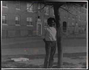 Young woman posing next to tree outside Newtowne Court
