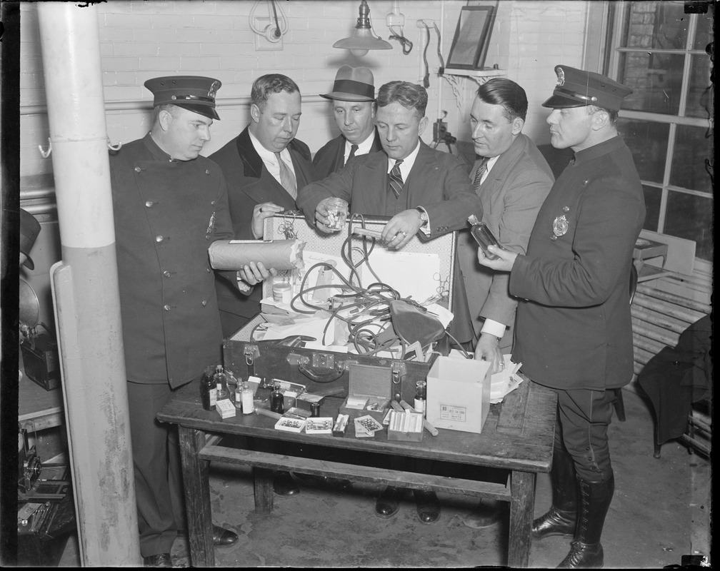 Police examine $3,000 worth of drugs and loot stolen from Mass. General Hospital by an orderly.