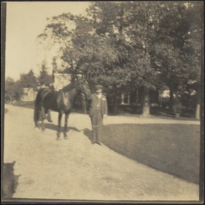 Man with horse in drive