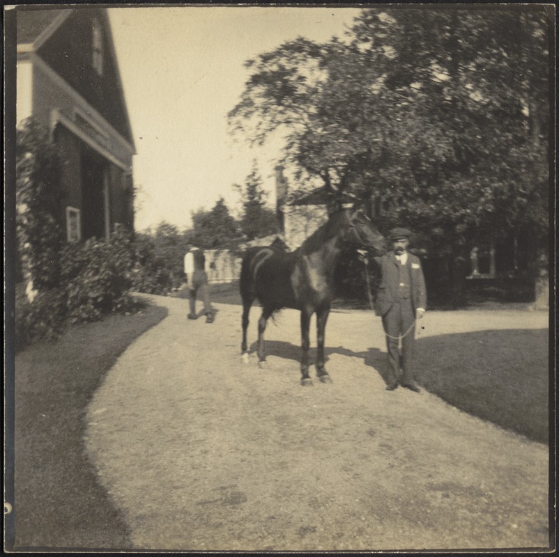 Man with horse in front of barn - Digital Commonwealth