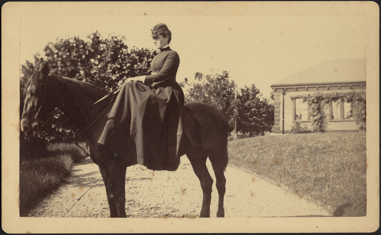 Ashdale Farm. Woman on horseback, possibly Gertrude S. Kunhardt; corner of brick building on right