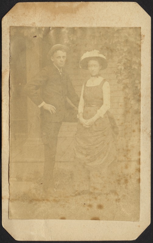 Young man and woman standing in front of house