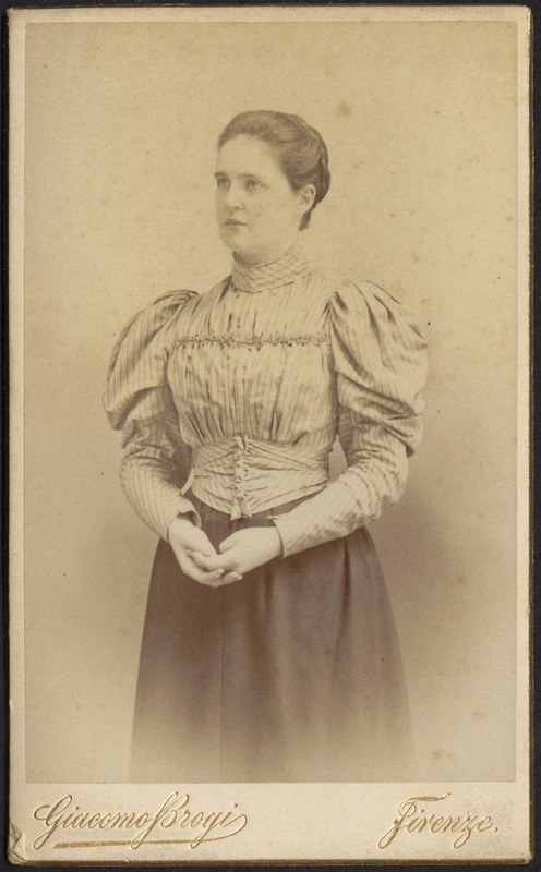 Portrait of young woman in striped top and dark skirt