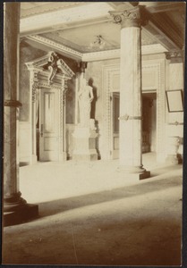 Neoclassical designed room with Corinthian columns and marble statue near doorway