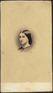 Young woman with dark hair pulled back into netted bun (head and shoulders)