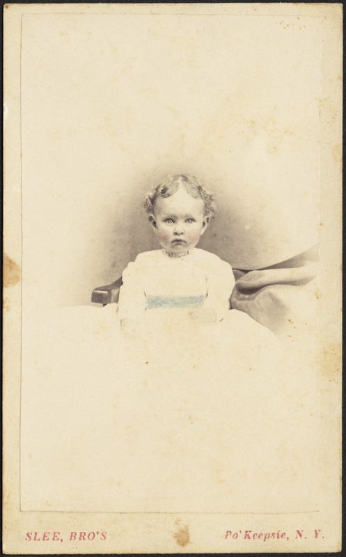 Young girl with blond curls, white frock