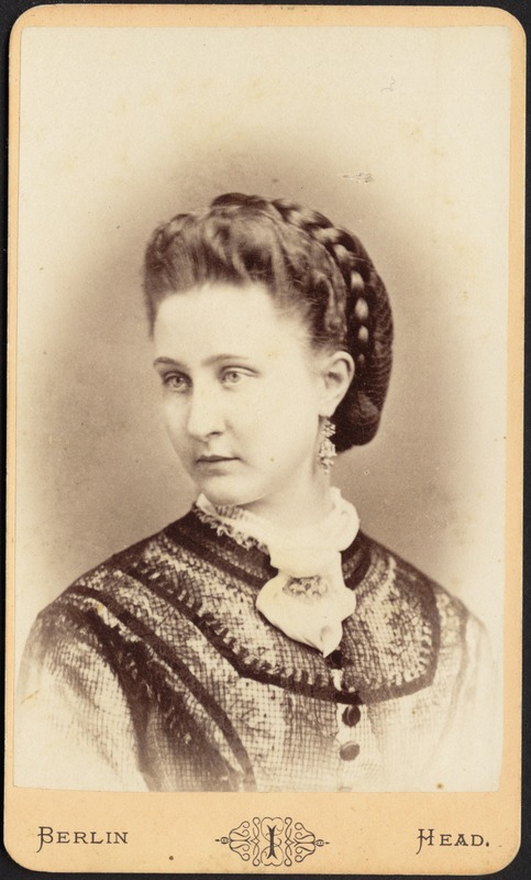 Woman with braided coiffure, ornate earrings