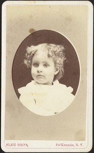 Young girl with light curly hair (head and shoulders in oval)